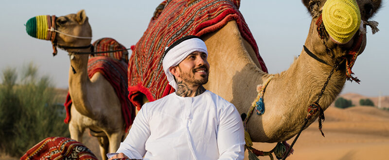 the famous Brazilian model Arthur O Urso in Dubai with camels